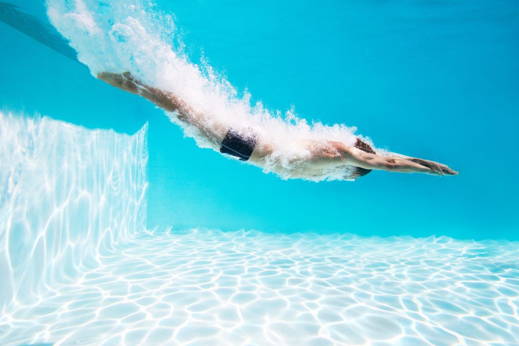 man diving into pool