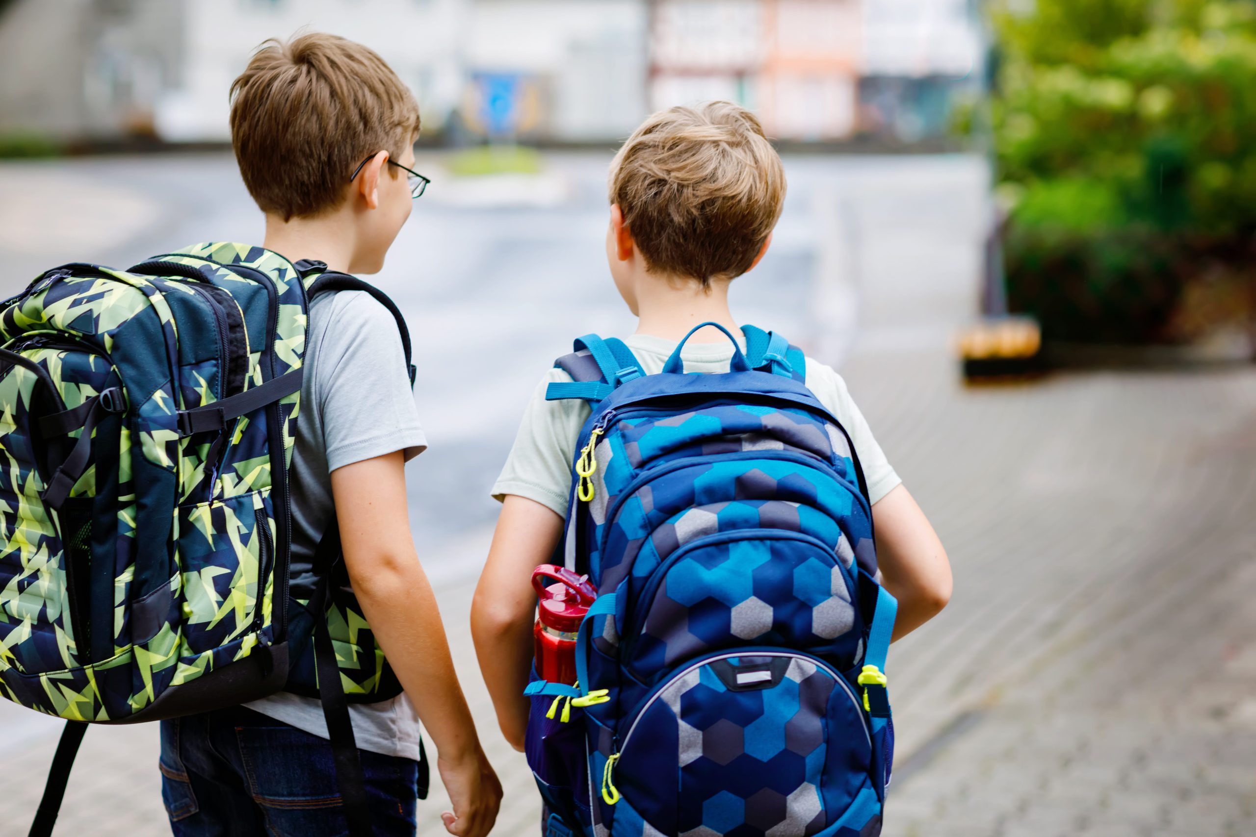 two boys wearing backpacks